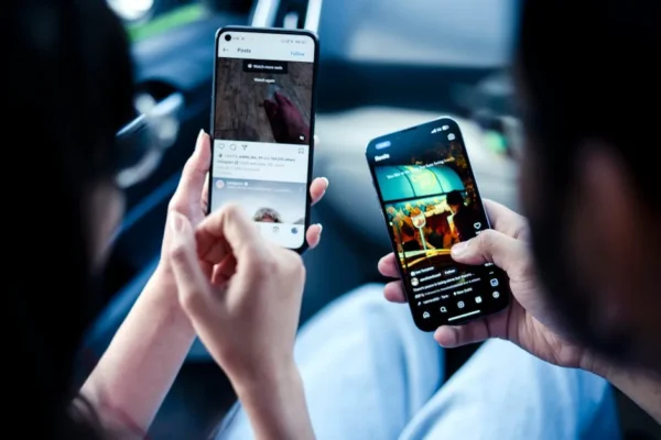 A couple engaging with social media on smartphones indoors, illustrating modern digital connectivity.