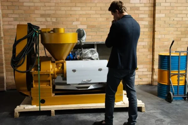 Entrepreneur examining industrial machinery in a modern warehouse setting.
